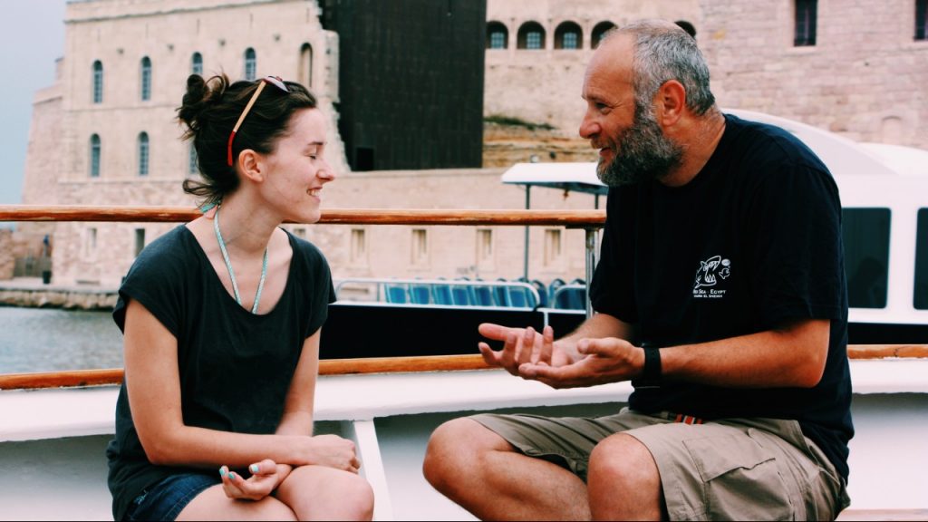 young woman talking with older man