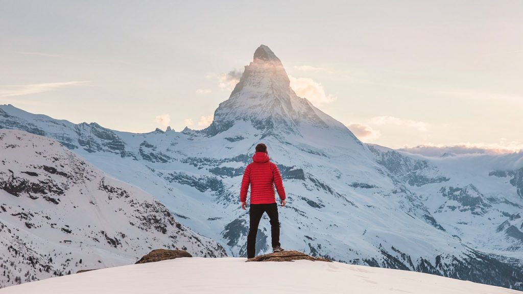 man in front of a mountain