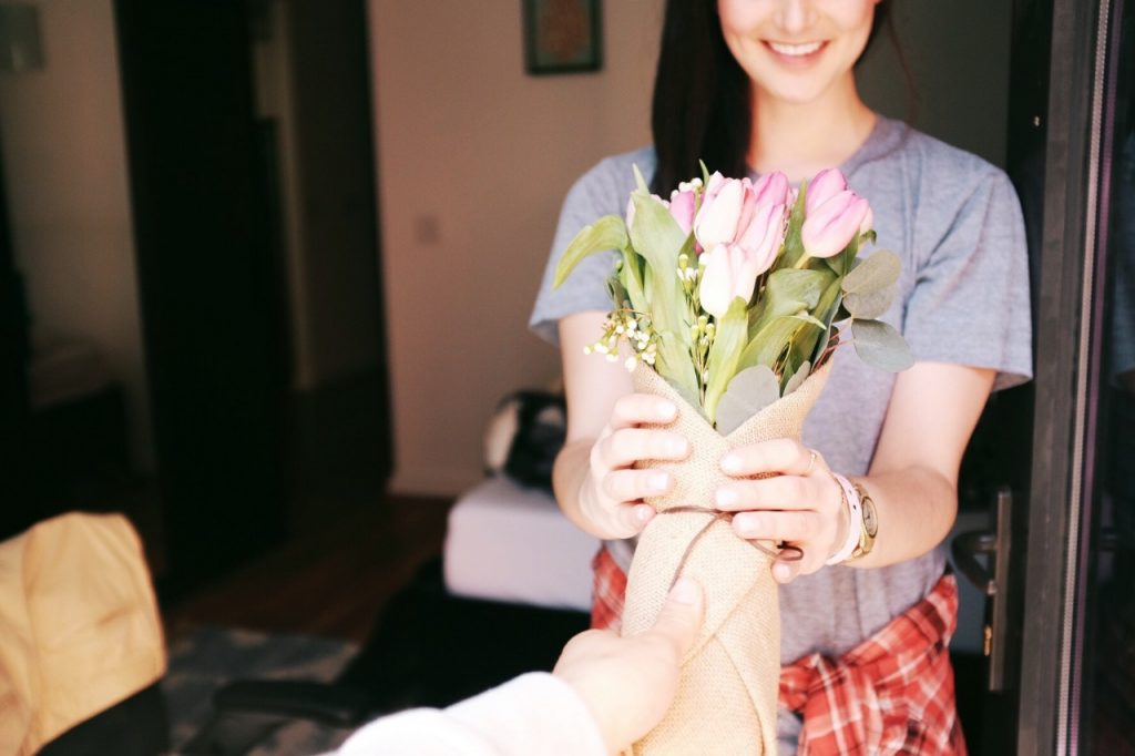 woman being handed flowers