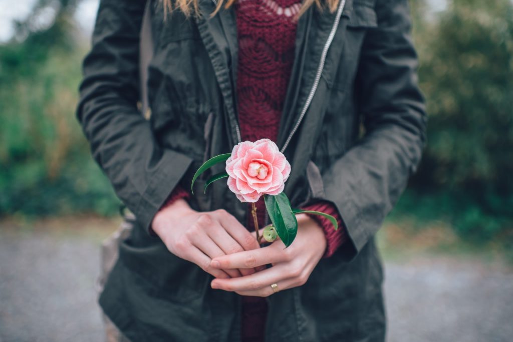 woman holding a flower