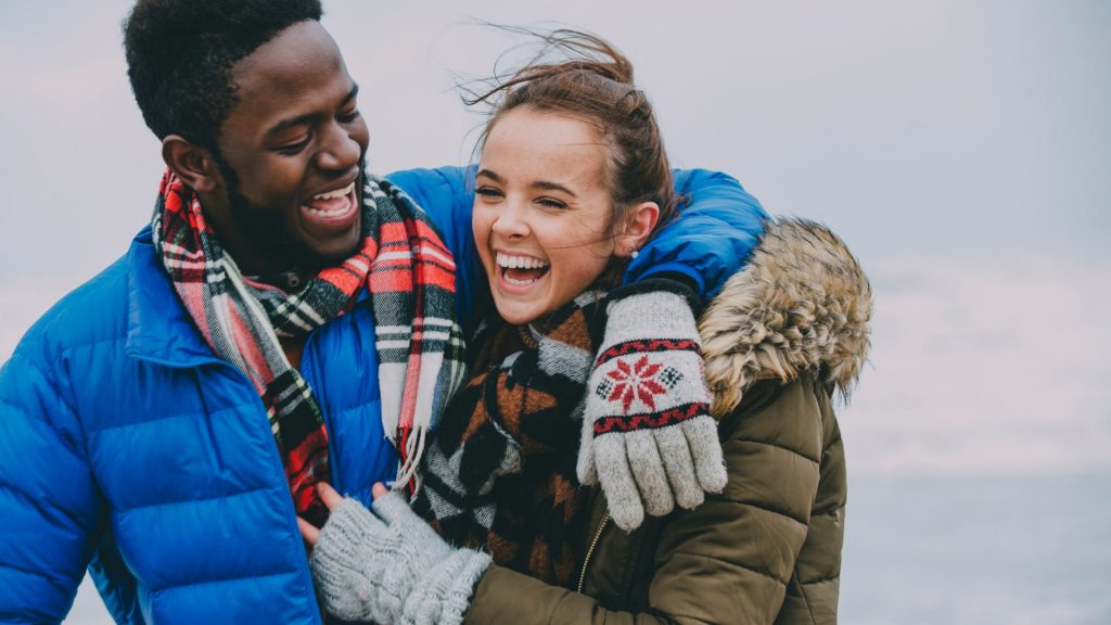 happy couple in winter on beach