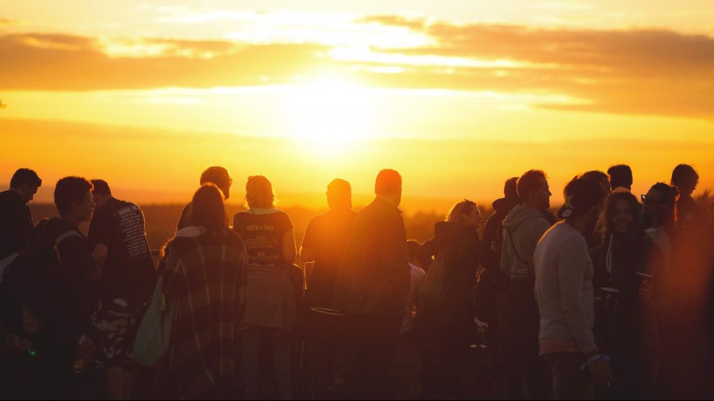 Group standing outside during sunset