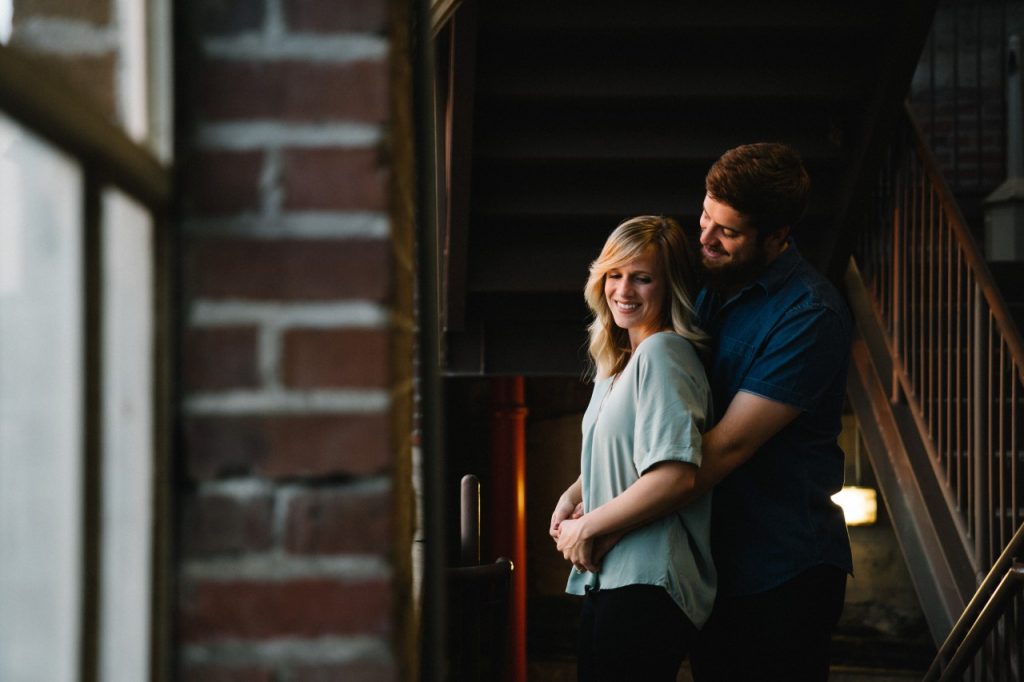 man hugging woman from behind