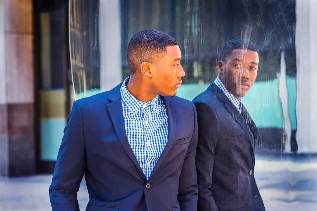 a man looking in a mirror, thinking about his identity