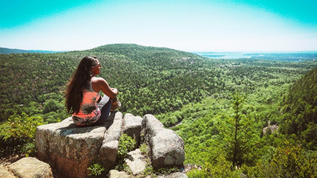 woman looking at green valley