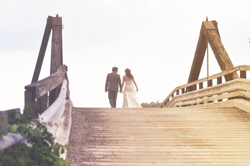couple walking across bridge