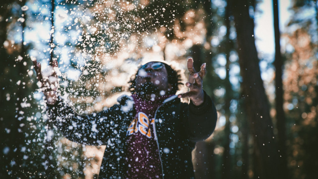 man throwing snow