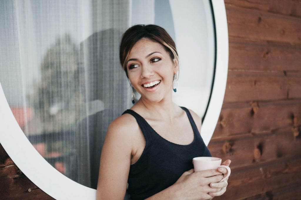 women with tea cup smiling