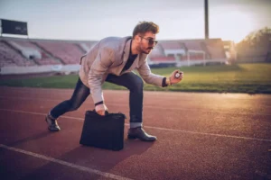 a business man, posed ready for a race