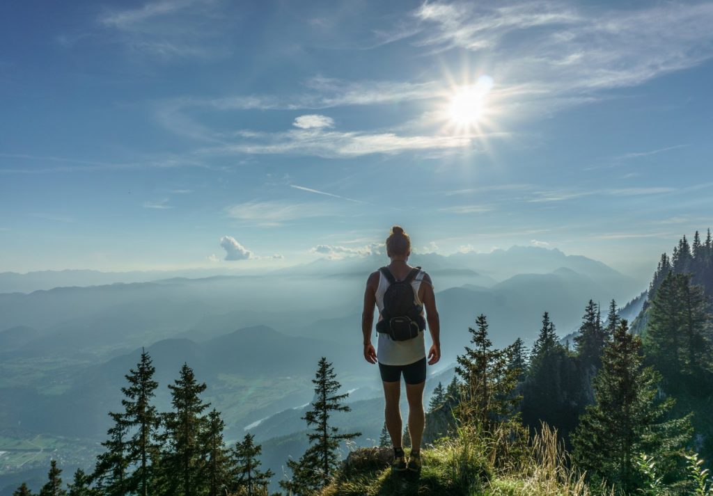 woman standing on top of mountain