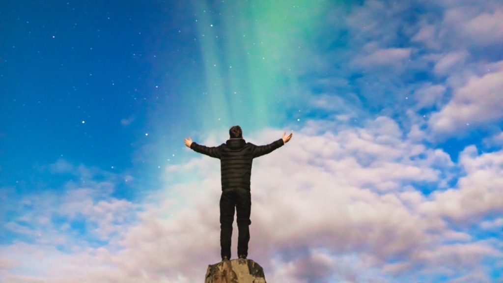 northern lights man on mountain