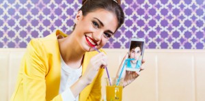girl holding phone with picture of guy on it