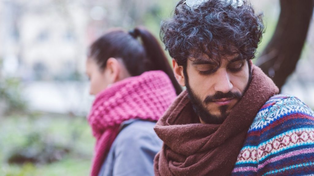 man and woman looking away from each other