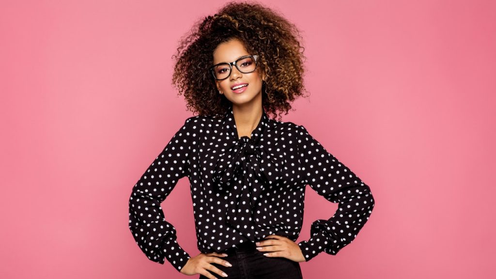 woman standing in front of pink background