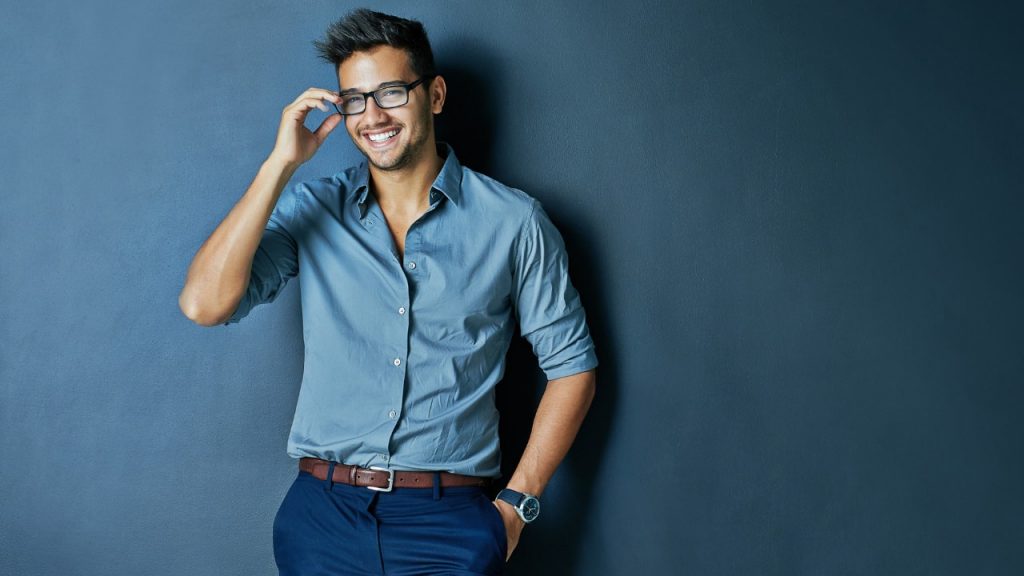 man standing in front of blue background