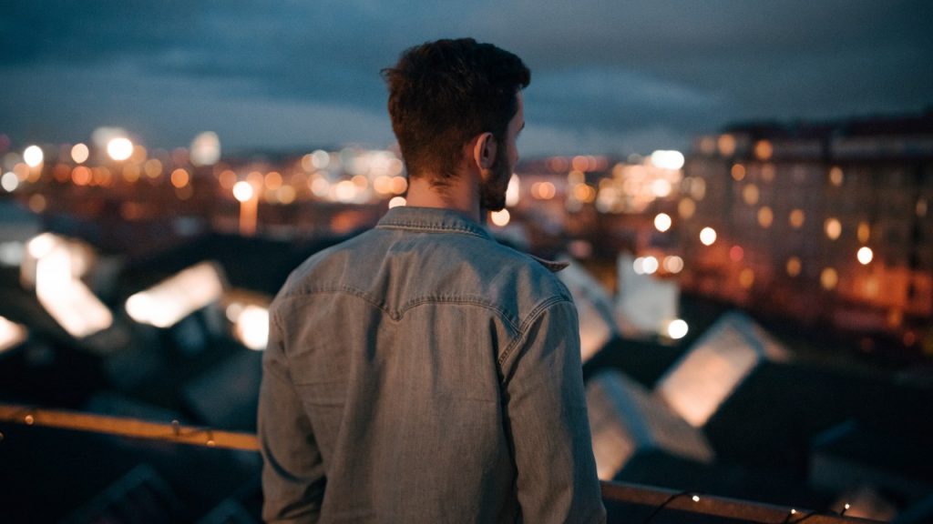 man looking over city