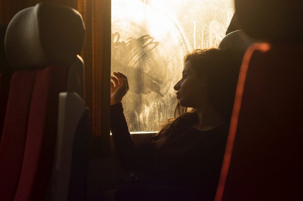 sad woman sitting on train