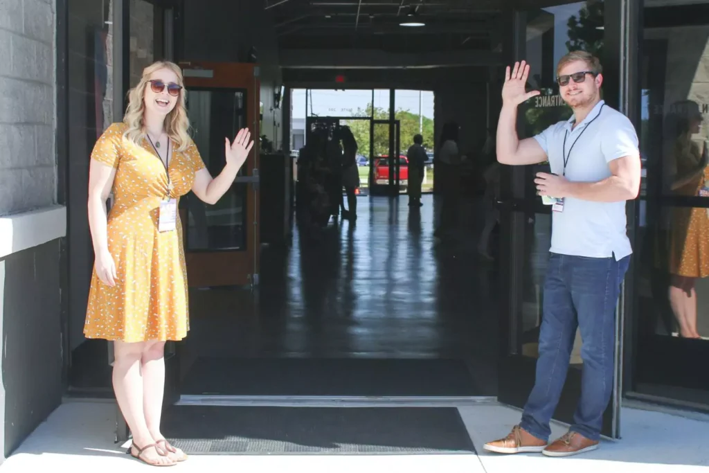 two people serving as greeters at their church