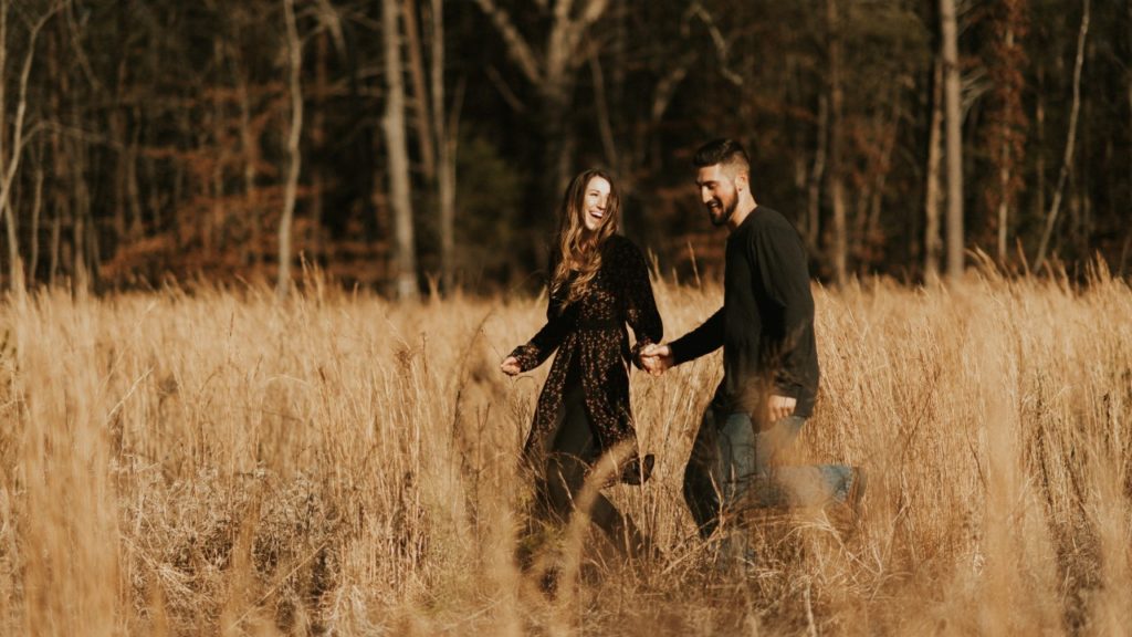 a couple walking in a field