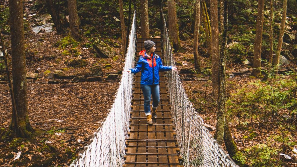 woman on forest bridge