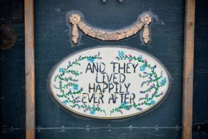 sign on a suitcase that says "and they lived happily ever after" a classic fairy tale ending