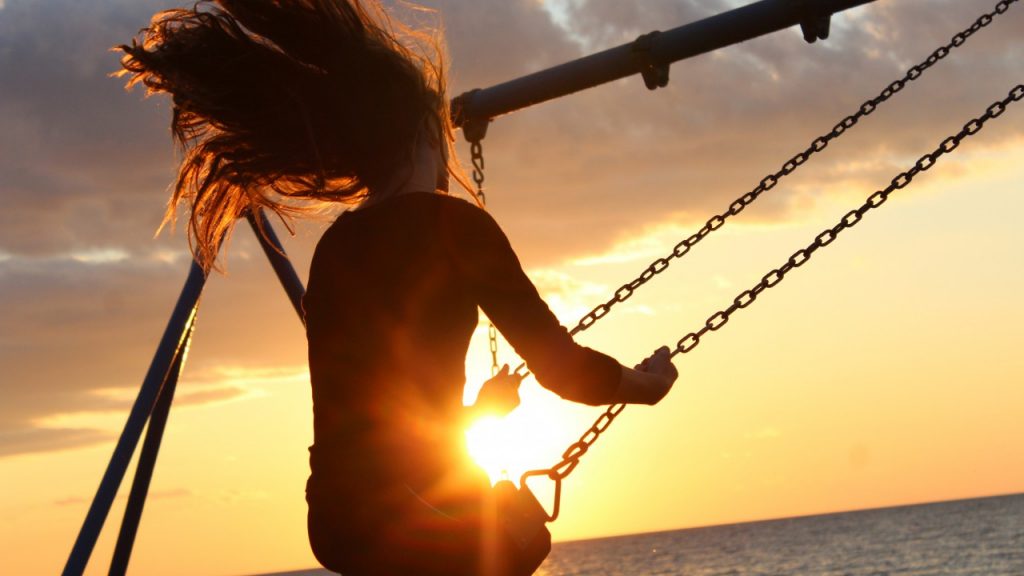 Woman on swing at beach