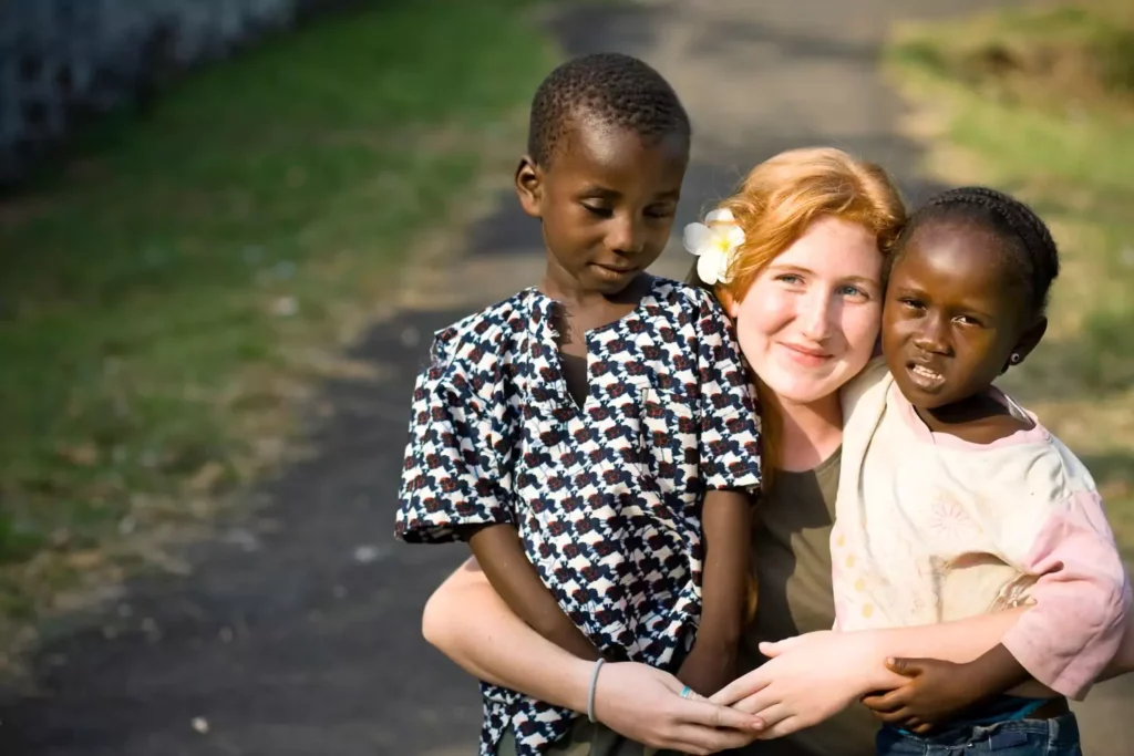 female missionary hugging two African children