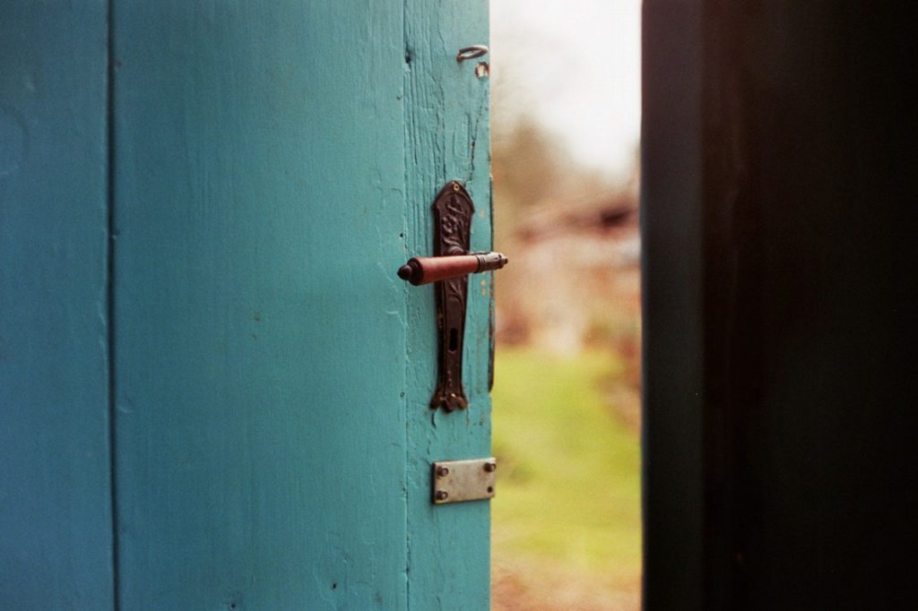 Door slightly opened to the outside