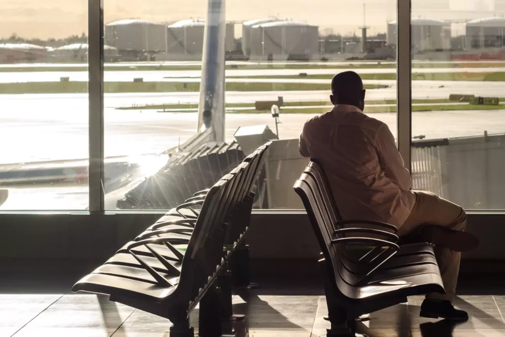 man waiting at an airport terminal thinking about ways to serve the Lord while he's waiting