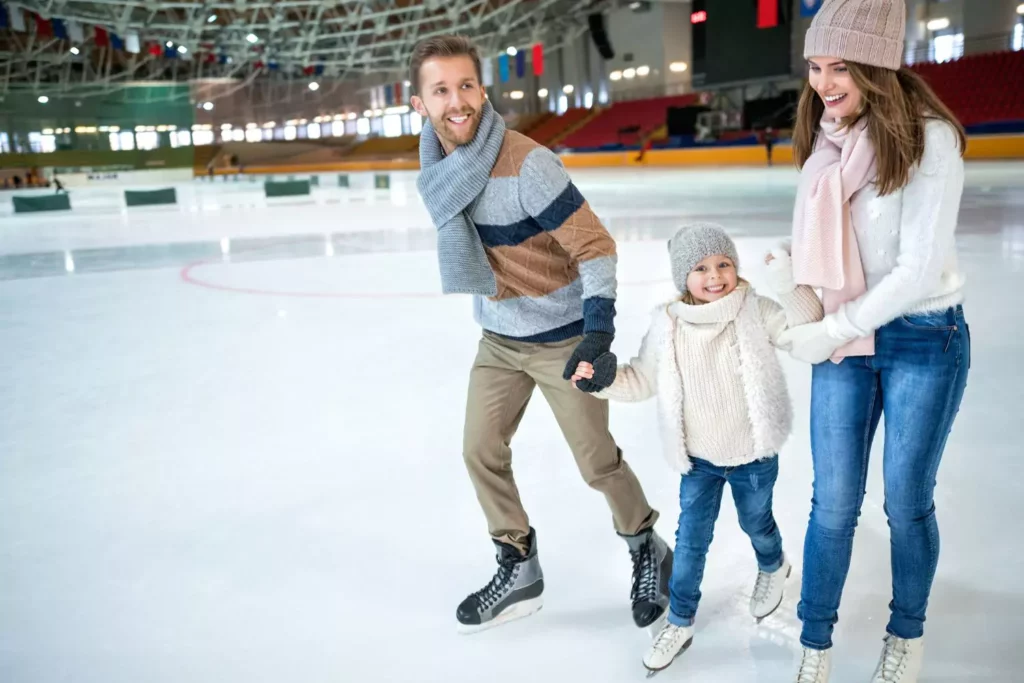 man, daughter, woman, ice skating and holding hands