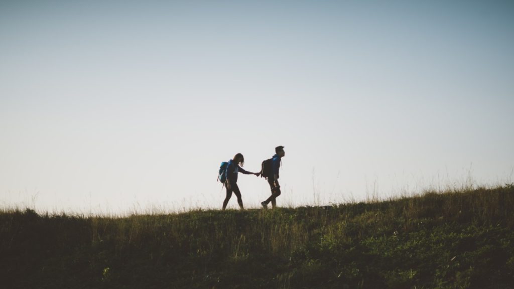 couple walking guy leading