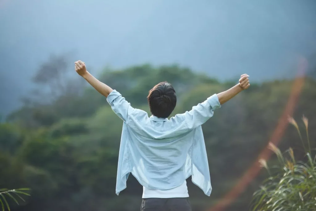 a man with his arms uplifted, fighting for joy