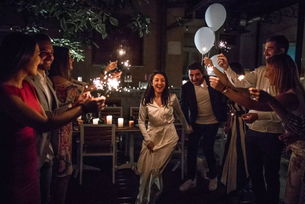 bride and groom exiting their wedding through a tunnel of their friends holding sparklers