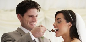 married couple at wedding eating cake