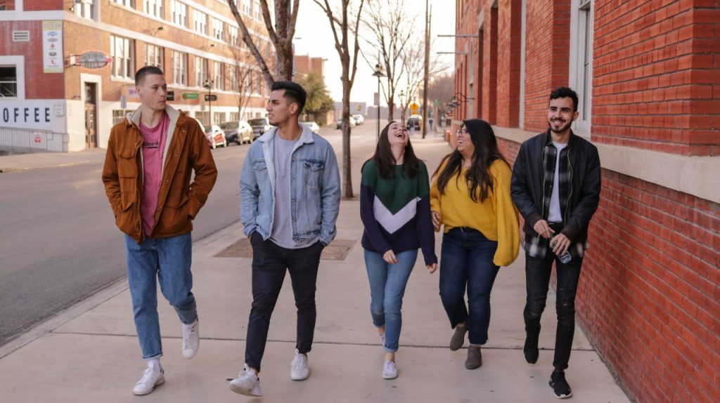 Friends walking on sidewalk