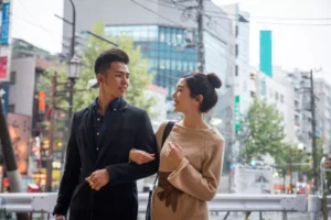 a man and woman in a dating relationship walking in a city