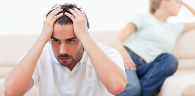 man with hands on his head looking frustrated