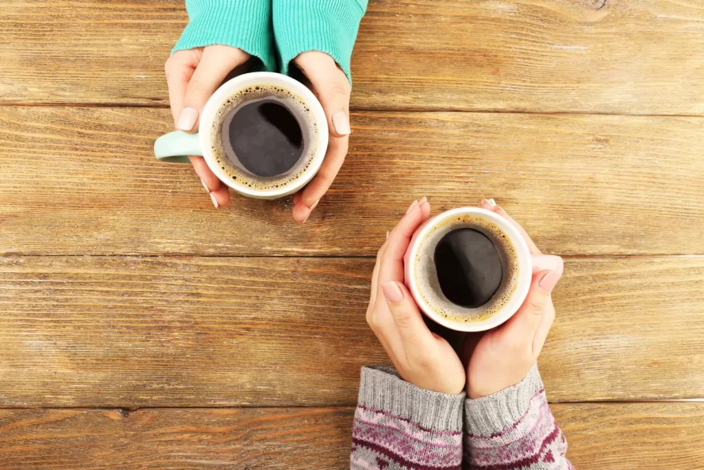two women holding coffee mugs, a new friendship has been formed