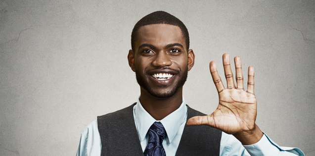 Young adult african american man holding up five fingers