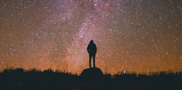 person standing beneath stars