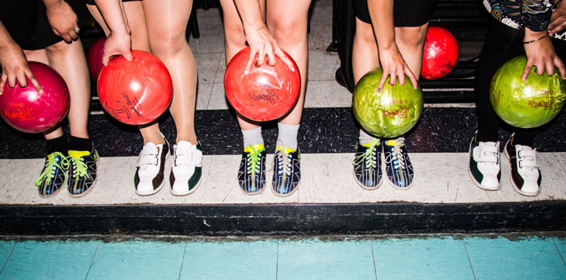 friends holding bowling balls
