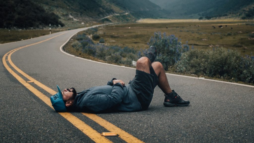 man resting on road