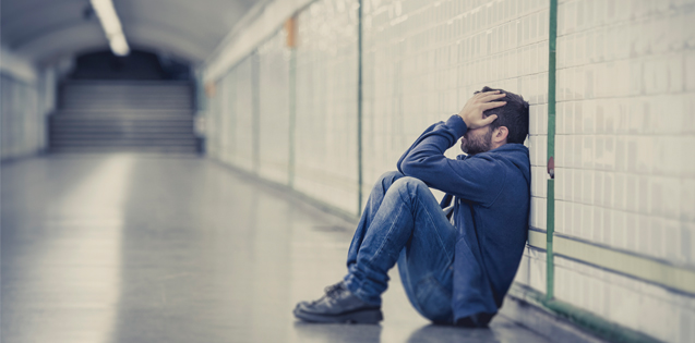 Man sitting alone in a tunnel