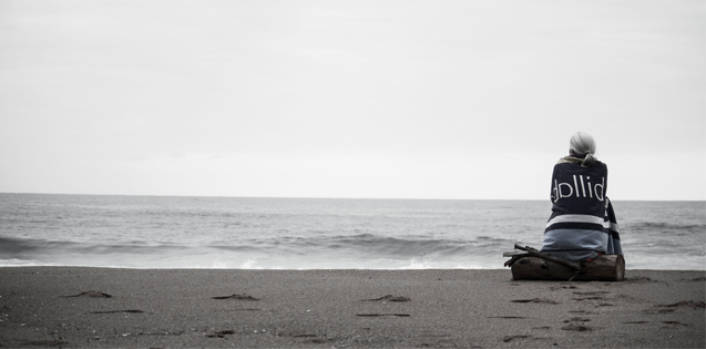 Woman sitting alone on a beach