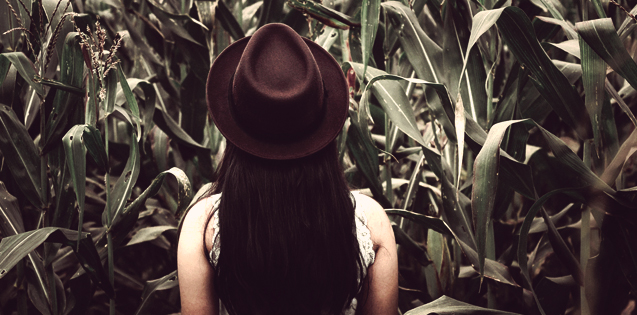 A woman standing in a corn field