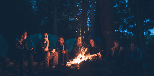 A group of friends sitting around a campfire