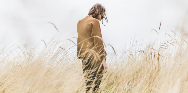 A woman standing alone in a field