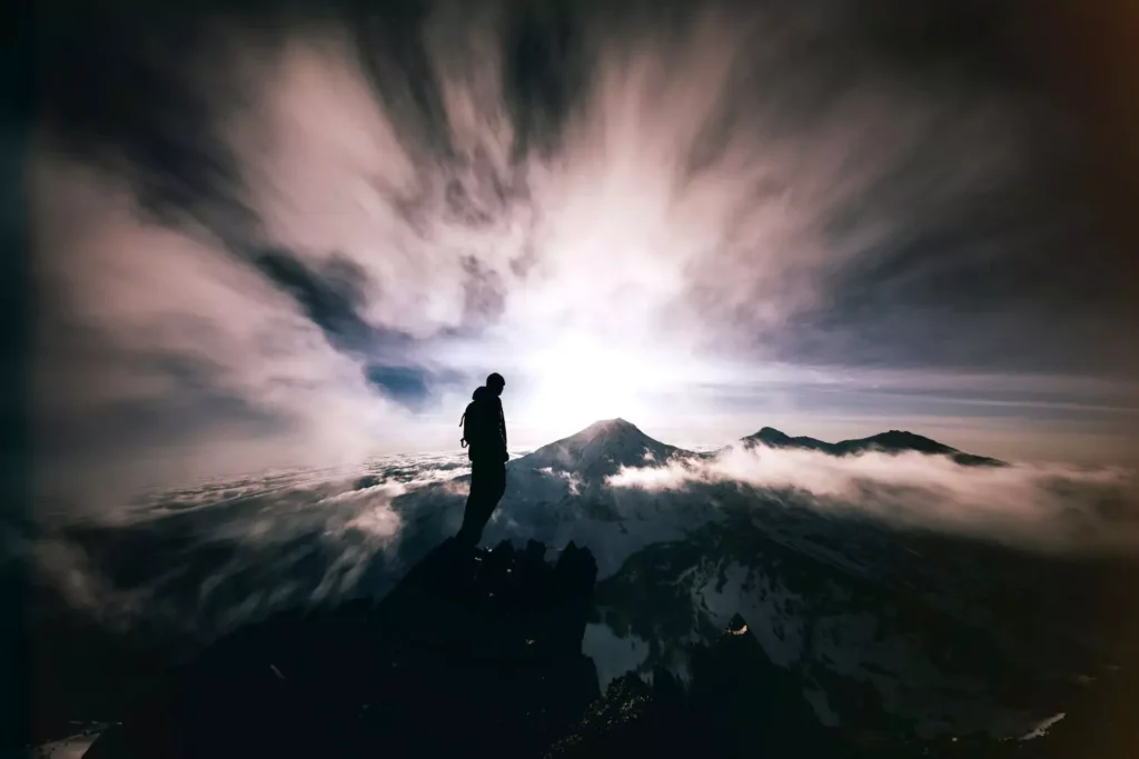 a man standing on a mountaintop, symbolizing the power of singleness