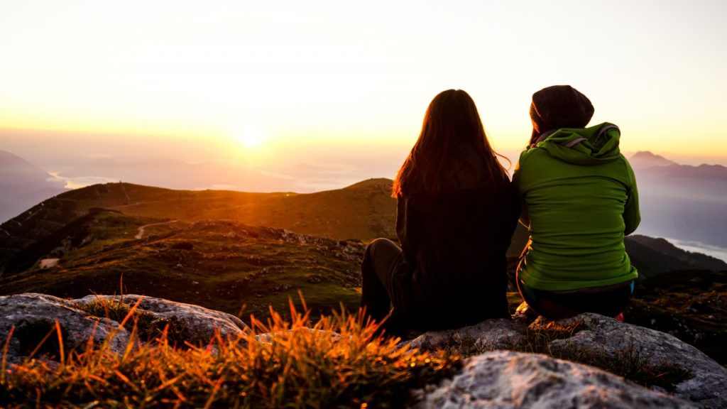 women sitting on mountain