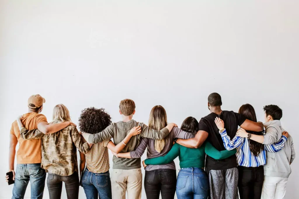 a group of people hugging, they are the church family